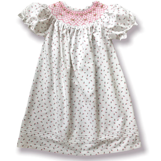 White dress with pink rosebud floral pattern on a white background
